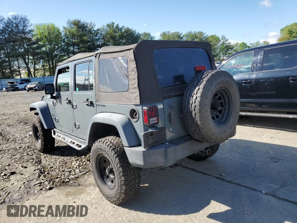 2015 Jeep Wrangler Unlimited Willys Wheeler with VIN 1C4BJWDG5FL609110, listed as a Copart auction lot 56013255 with 153,202 mi miles and Clean Title. Bid and sale history available at DreamBid. Image 2.