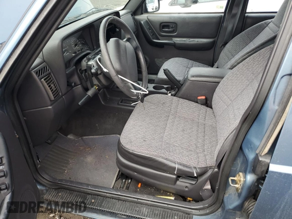 1999 Jeep Cherokee Sport with VIN 1J4FT68S1XL577603, listed as a Copart auction lot 54216115 with 180,128 mi miles and Salvage title. Bid and sale history available at DreamBid. Image 7.