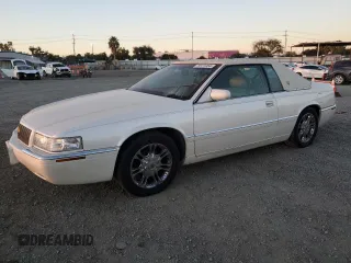 2002 Cadillac Eldorado z VIN 1G6EL12Y72B101231, wystawiony jako Copart lot #79971954 z przebiegiem 87 408 mil mil oraz Szkoda całkowita • Salvage title. Historia ofert i sprzedaży dostępna na DreamBid. Obrazek 1.