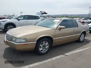 1999 Cadillac Eldorado ESC z VIN 1G6EL12Y5XU603764, wystawiony jako IAAI lot #42368692 z przebiegiem 154 613 mil mil oraz . Historia ofert i sprzedaży dostępna na DreamBid. Obrazek 2.
