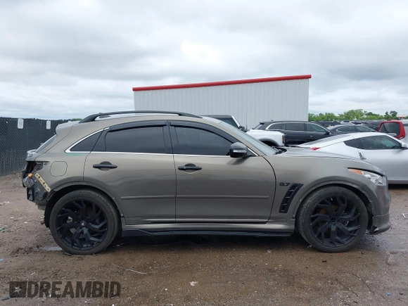 2014 Infiniti QX70 z VIN JN8CS1MU3EM451745, wystawiony jako IAAI lot #42203922 z przebiegiem 144 990 mil mil oraz . Historia ofert i sprzedaży dostępna na DreamBid. Obrazek 13.