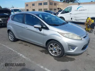 2011 Ford Fiesta SES with VIN 3FADP4FJ1BM102434, listed as a IAAI auction lot 41703287 with 124,476 mi miles. Bid and sale history available at carsss.com. Image 1.