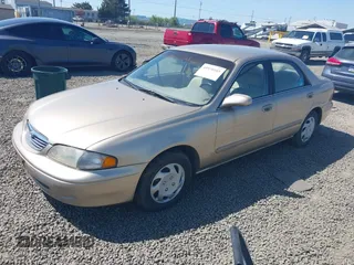 1999 Mazda 626 ES z VIN 1YVGF22C5X5811946, wystawiony jako IAAI lot #41970165 z przebiegiem 126 709 mil mil oraz . Historia ofert i sprzedaży dostępna na DreamBid. Obrazek 2.