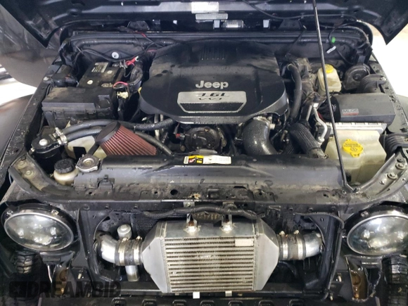 2013 Jeep Wrangler Rubicon with VIN 1C4BJWCG1DL584611, listed as a Copart auction lot 71536944 with 142,975 mi miles and Salvage title. Bid and sale history available at DreamBid. Image 14.