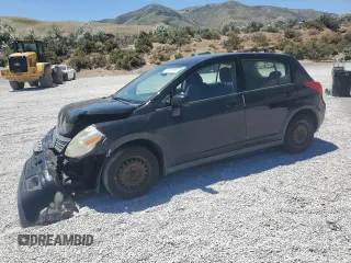 2009 Nissan Versa S with VIN 3N1BC13E79L432830, listed as a Copart auction lot 61031815 with 128,102 mi miles and Salvage title. Bid and sale history available at DreamBid. Image 1.
