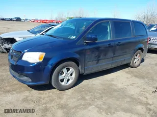 2013 Dodge Grand Caravan SXT with VIN 2C4RDGCGXDR527973, listed as a IAAI auction lot 41930036 with 111,985 mi miles. Bid and sale history available at carsss.com. Image 2.