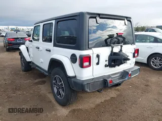 2023 Jeep Wrangler Sahara with VIN 1C4HJXEN7PW701607, listed as a IAAI auction lot 41774580 with 13,376 mi miles. Bid and sale history available at carsss.com. Image 3.