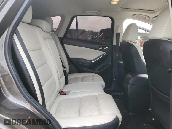 2016 Mazda CX-5 Grand Touring z VIN JM3KE2DY7G0735355, wystawiony jako Copart lot #49438285 z przebiegiem 132 731 mil mil oraz Szkoda całkowita • Salvage title. Historia ofert i sprzedaży dostępna na DreamBid. Obrazek 11.
