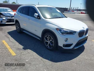 2017 BMW X1 xDrive28i with VIN WBXHT3C33H5F86831, listed as a IAAI auction lot 42019082 with 74,708 mi miles. Bid and sale history available at carsss.com. Image 1.