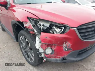 2016 Mazda CX-5 Grand Touring with VIN JM3KE2DY8G0871574, listed as a IAAI auction lot 41959686 with 95,416 mi miles and . Bid and sale history available at DreamBid. Image 6.