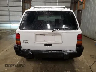 1995 Jeep Grand Cherokee Laredo with VIN 1J4GZ58S6SC630947, listed as a Copart auction lot 82143564 with 267,946 mi miles and Salvage Title. Bid and sale history available at carsss.com. Image 6.