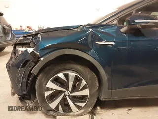 2023 Volkswagen ID.4 Pro z VIN 1V2DNPE84PC038042, wystawiony jako IAAI lot #41446269 z przebiegiem 12 878 mil mil oraz . Historia ofert i sprzedaży dostępna na DreamBid. Obrazek 20.