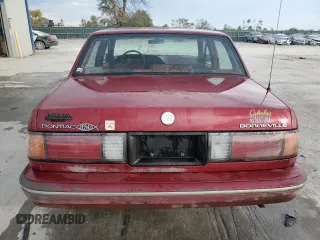 1990 Pontiac Bonneville z VIN 1G2HX54C7L1244134, wystawiony jako Copart lot #77859884 z przebiegiem 104 905 mil mil oraz Czysty tytuł • Clean title. Historia ofert i sprzedaży dostępna na DreamBid. Obrazek 6.