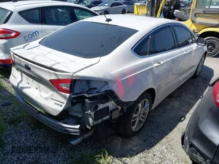 2016 Ford Fusion Titanium Hybrid with VIN 3FA6P0RU1GR259947, listed as a IAAI auction lot 41695377 with 97,605 mi miles. Bid and sale history available at carsss.com. Image 4.