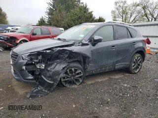 2016 Mazda CX-5 Grand Touring z VIN JM3KE2DY9G0687261, wystawiony jako Copart lot #52865415 z przebiegiem Nie podano mil oraz Szkoda całkowita • Salvage title. Historia ofert i sprzedaży dostępna na DreamBid. Obrazek 1.