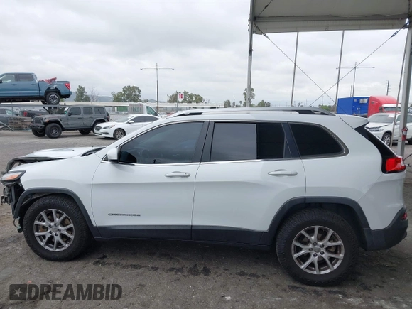 2015 Jeep Cherokee Latitude with VIN 1C4PJLCB5FW642701, listed as a IAAI auction lot 42063262 with 142,501 mi miles and . Bid and sale history available at carsss.com. Image 14.