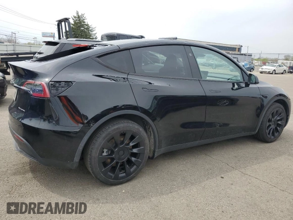 2023 Tesla Model Y Long Range z VIN 7SAYGDEE0PF869710, wystawiony jako Copart lot #52885365 z przebiegiem 13 919 mil mil oraz Szkoda całkowita • Salvage title. Historia ofert i sprzedaży dostępna na DreamBid. Obrazek 3.