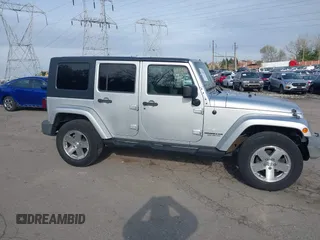 2009 Jeep Wrangler Unlimited Sahara with VIN 1J4GA59129L780013, listed as a IAAI auction lot 41976308 with 164,738 mi miles. Bid and sale history available at carsss.com. Image 14.