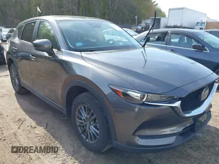 2021 Mazda CX-5 Touring z VIN JM3KFBCM0M1327359, wystawiony jako IAAI lot #42177618 z przebiegiem 63 717 mil mil oraz . Historia ofert i sprzedaży dostępna na DreamBid. Obrazek 1.