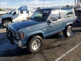 1986 Ford Bronco z VIN 1FMCU14T3GUC48074, wystawiony jako Copart lot #77661364 z przebiegiem 69 799 mil mil oraz Czysty tytuł • Clean title. Historia ofert i sprzedaży dostępna na DreamBid. Obrazek 1.