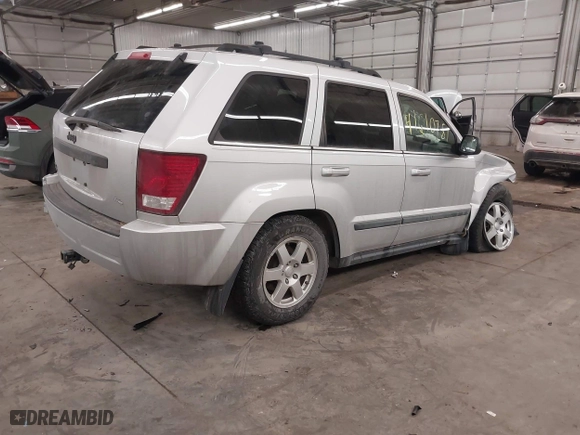 2009 Jeep Grand Cherokee Laredo with VIN 1J8GR48KX9C516873, listed as a IAAI auction lot 41610781 with 199,246 mi miles. Bid and sale history available at carsss.com. Image 4.