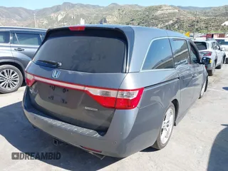 2011 Honda Odyssey Touring with VIN 5FNRL5H96BB009580, listed as a IAAI auction lot 42202595 with Not provided miles and . Bid and sale history available at DreamBid. Image 4.