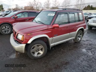 1996 Suzuki Sidekick z VIN JS3TD21V2T4103586, wystawiony jako Copart lot #83492154 z przebiegiem 98 298 mil mil oraz Szkody całkowita. Historia ofert i sprzedaży dostępna na DreamBid. Obrazek 1.