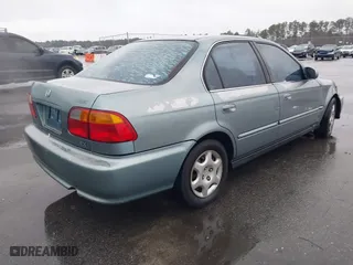1999 Honda Civic EX with VIN 1HGEJ8643XL010821, listed as a IAAI auction lot 41602036 with 165,139 mi miles. Bid and sale history available at carsss.com. Image 4.