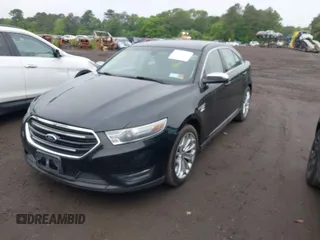 2014 Ford Taurus Limited z VIN 1FAHP2J8XEG112310, wystawiony jako IAAI lot #42367397 z przebiegiem 77 329 mil mil oraz . Historia ofert i sprzedaży dostępna na DreamBid. Obrazek 2.