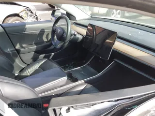 2018 Tesla Model 3 Long Range Battery with VIN 5YJ3E1EB5JF063077, listed as a IAAI auction lot 41773551 with 99,477 mi miles and . Bid and sale history available at DreamBid. Image 5.