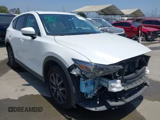 2018 Mazda CX-5 Grand Touring with VIN JM3KFBDM9J0375328, listed as a IAAI auction lot 42517222 with 148,056 mi miles and . Bid and sale history available at DreamBid. Image 1.