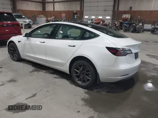 2021 Tesla Model 3 Long Range with VIN 5YJ3E1EBXMF051060, listed as a IAAI auction lot 41958018 with 65,631 mi miles. Bid and sale history available at carsss.com. Image 3.