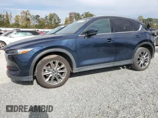 2021 Mazda CX-5 Signature with VIN JM3KFBEY3M0439658, listed as a Copart auction lot 74534464 with 50,816 mi miles and Salvage Title. Bid and sale history available at carsss.com. Image 1.