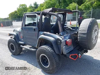 2001 Jeep Wrangler Sport z VIN 1J4FA49S11P322636, wystawiony jako IAAI lot #42409917 z przebiegiem 88 675 mil mil oraz . Historia ofert i sprzedaży dostępna na DreamBid. Obrazek 3.