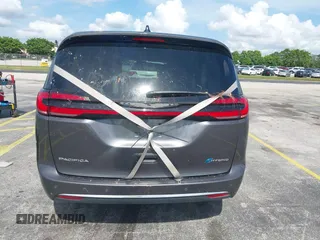 2023 Chrysler Pacifica Hybrid Touring L with VIN 2C4RC1L74PR579782, listed as a IAAI auction lot 42487390 with Not provided miles and . Bid and sale history available at DreamBid. Image 17.