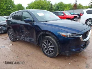 2018 Mazda CX-5 Grand Touring z VIN JM3KFBDM7J0400730, wystawiony jako IAAI lot #42365378 z przebiegiem 159 034 mil mil oraz . Historia ofert i sprzedaży dostępna na DreamBid. Obrazek 1.