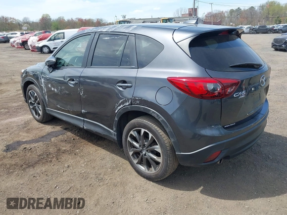 2016 Mazda CX-5 Grand Touring z VIN JM3KE4DY1G0893119, wystawiony jako IAAI lot #42049614 z przebiegiem 102 506 mil mil oraz . Historia ofert i sprzedaży dostępna na DreamBid. Obrazek 3.