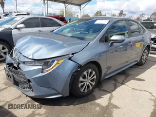 2021 Toyota Corolla Hybrid LE with VIN JTDEAMDE0MJ026601, listed as a IAAI auction lot 41797452 with 85,294 mi miles. Bid and sale history available at carsss.com. Image 2.