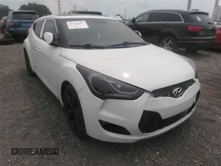 2016 Hyundai Veloster z VIN KMHTC6AD1GU291714, wystawiony jako IAAI lot #42144337 z przebiegiem 99 067 mil mil oraz . Historia ofert i sprzedaży dostępna na DreamBid. Obrazek 1.