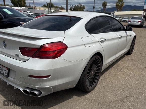 2015 BMW 6 Series 650i xDrive with VIN WBA6B4C57FD899926, listed as a Copart auction lot 54974505 with 63,570 mi miles and Salvage Title. Bid and sale history available at carsss.com. Image 4.