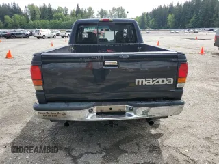 1994 Mazda B-Series Truck LE z VIN 4F4CR16X7RTM18152, wystawiony jako Copart lot #56992165 z przebiegiem 238 802 mil mil oraz Szkody całkowita. Historia ofert i sprzedaży dostępna na DreamBid. Obrazek 6.