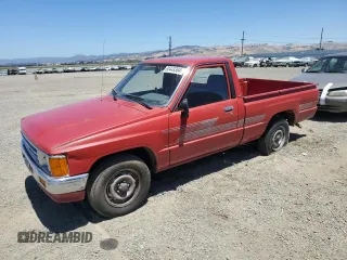 1987 Toyota Pickup with VIN JT4RN50R2H0292900, listed as a Copart auction lot 60449384 with 153,296 mi miles and Salvage Title. Bid and sale history available at DreamBid. Image 1.