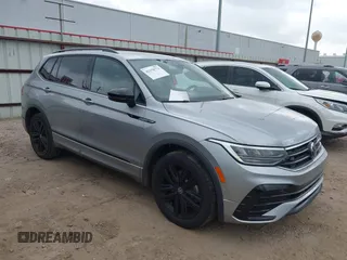 2022 Volkswagen Tiguan SE R-Line Black with VIN 3VVCB7AXXNM165748, listed as a IAAI auction lot 42178772 with 64,007 mi miles and . Bid and sale history available at DreamBid. Image 1.