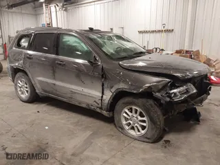 2018 Jeep Grand Cherokee Laredo E with VIN 1C4RJFAG4JC313054, listed as a IAAI auction lot 41469450 with 142,929 mi miles. Bid and sale history available at carsss.com. Image 1.