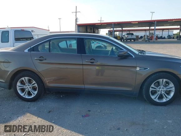 2015 Ford Taurus SEL z VIN 1FAHP2E84FG125243, wystawiony jako IAAI lot #42045847 z przebiegiem 42 093 mil mil oraz . Historia ofert i sprzedaży dostępna na DreamBid. Obrazek 13.