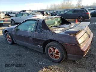 1986 Pontiac Fiero z VIN 1G2PF3793GP210763, wystawiony jako Copart lot #41891075 z przebiegiem 144 219 mil mil oraz Czysty tytuł • Clean title. Historia ofert i sprzedaży dostępna na DreamBid. Obrazek 2.