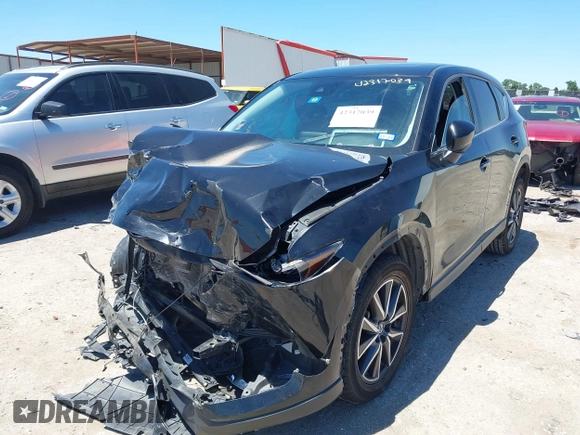 2018 Mazda CX-5 Touring z VIN JM3KFACM3J1339074, wystawiony jako IAAI lot #42317039 z przebiegiem 82 799 mil mil oraz . Historia ofert i sprzedaży dostępna na DreamBid. Obrazek 2.