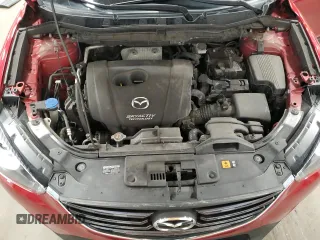 2016 Mazda CX-5 Touring z VIN JM3KE4CY7G0898598, wystawiony jako Copart lot #56717895 z przebiegiem 103 548 mil mil oraz Szkoda całkowita • Salvage title. Historia ofert i sprzedaży dostępna na DreamBid. Obrazek 12.