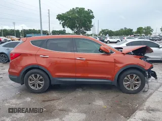 2015 Hyundai Santa Fe z VIN 5XYZT3LB7FG299504, wystawiony jako IAAI lot #42434744 z przebiegiem 104 570 mil mil oraz . Historia ofert i sprzedaży dostępna na DreamBid. Obrazek 13.