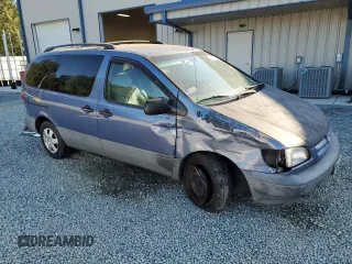 1999 Toyota Sienna LE with VIN 4T3ZF13C8XU108650, listed as a Copart auction lot 74476004 with 215,060 mi miles and Salvage Title. Bid and sale history available at carsss.com. Image 4.